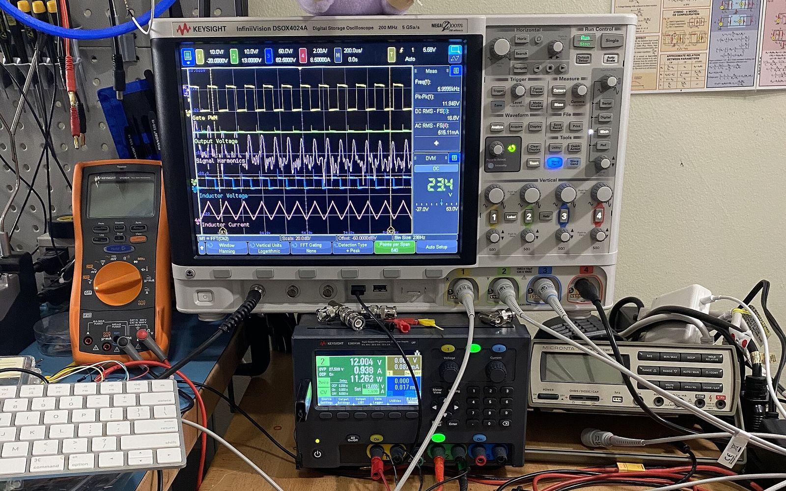 Electronics test bench with an oscilloscope, 12 V bench power supply, and multimeter